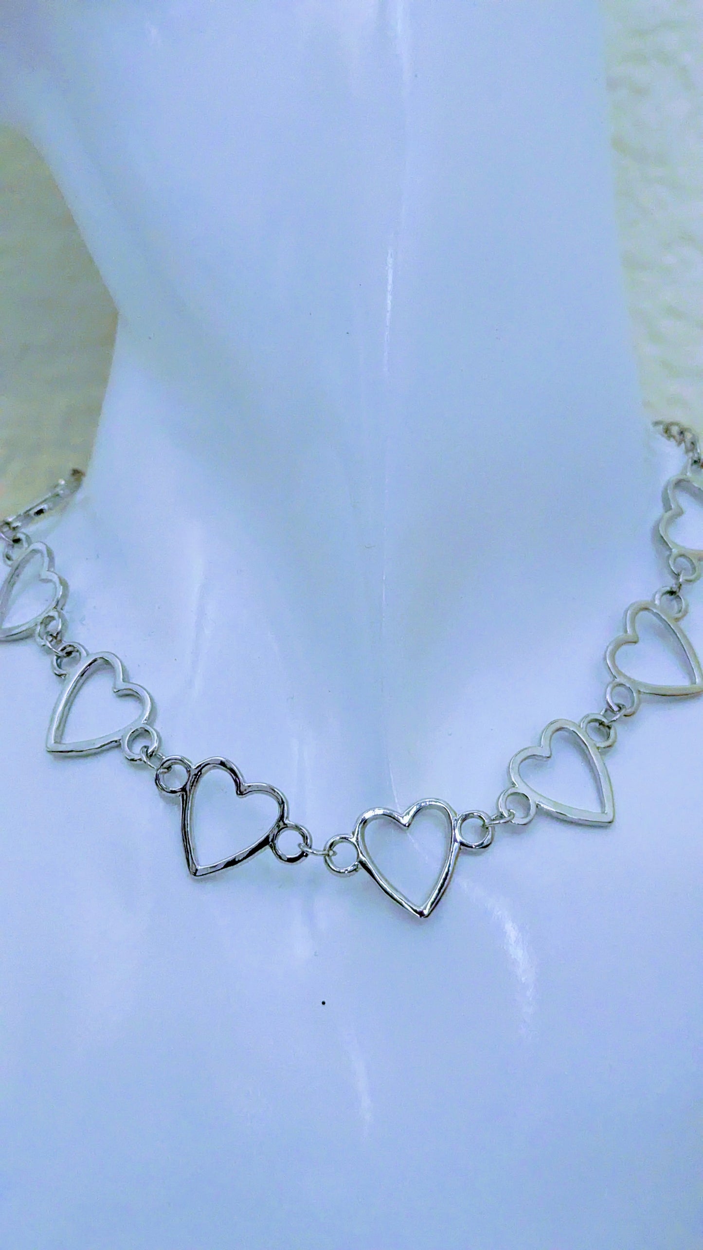 Silver heart-shaped bracelet on a white background