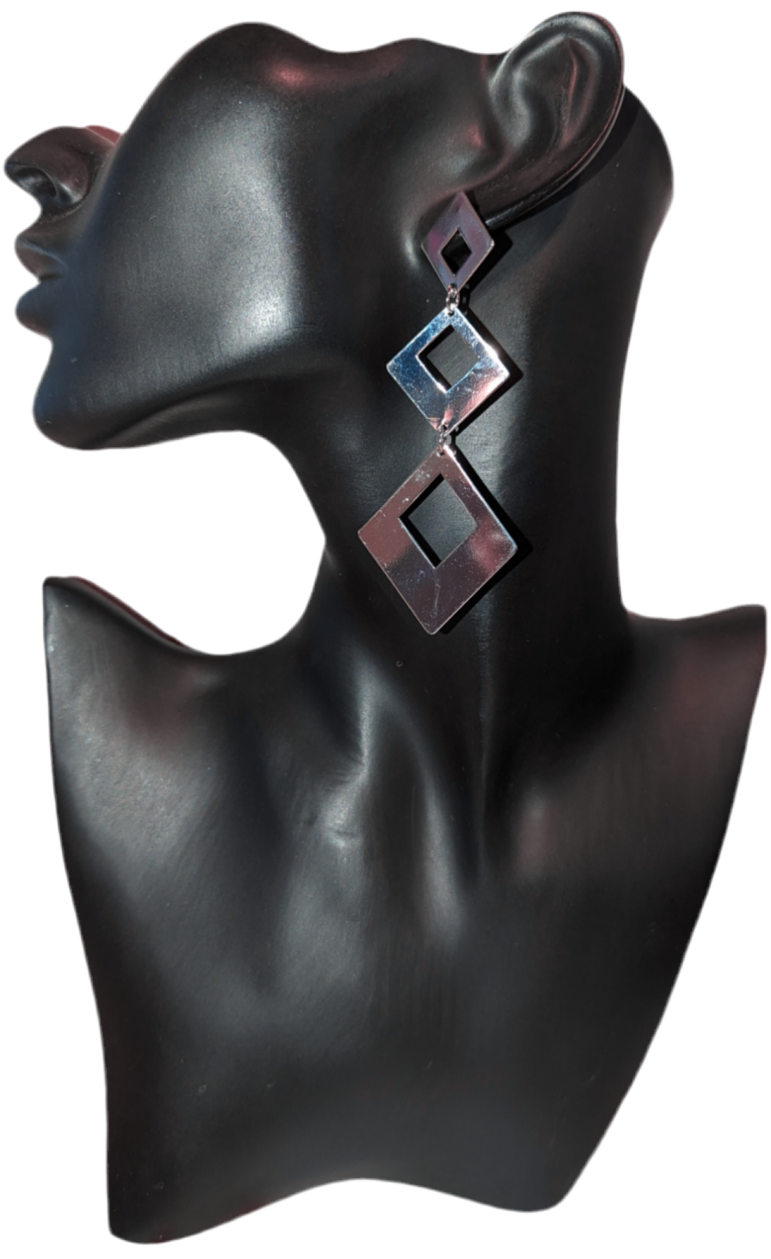 Silver geometric earrings on a black mannequin bust