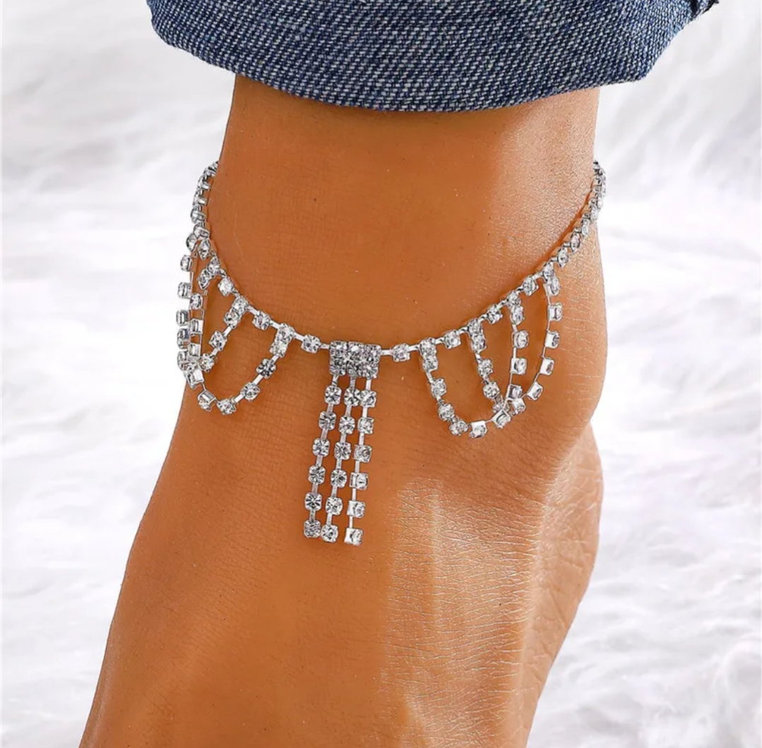 Barefoot sandal with crystal anklet on a white background