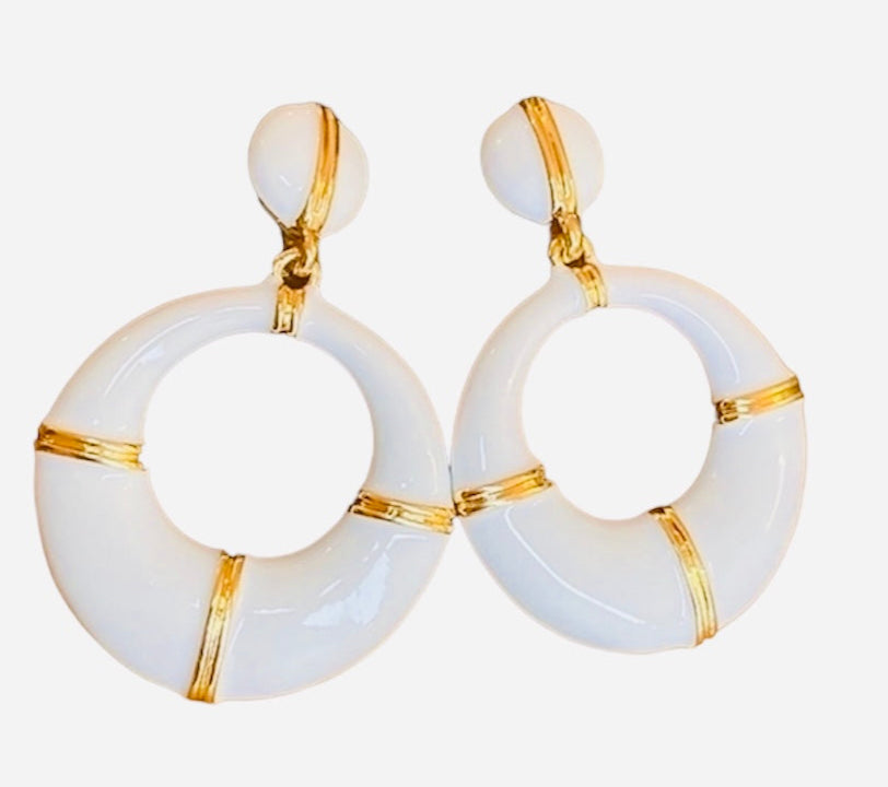 Pair of earrings with gold accents on a white background
