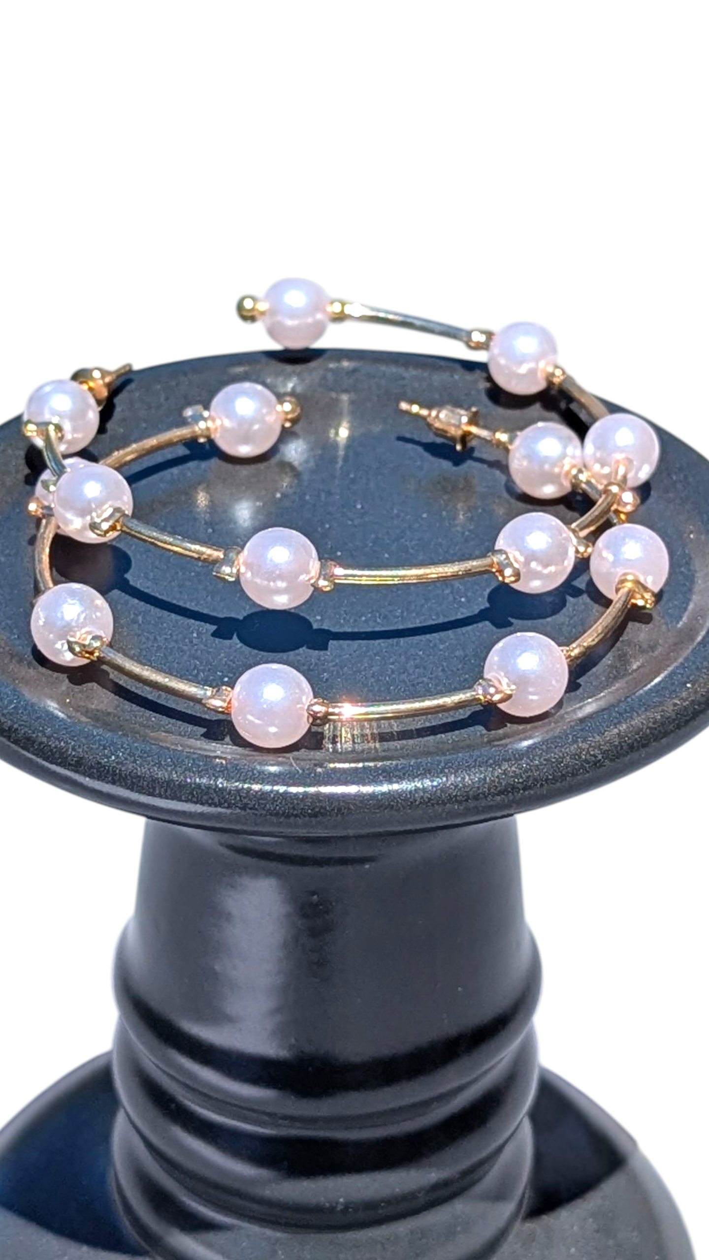 Decorative item with pearl-like beads on a dark blue stand