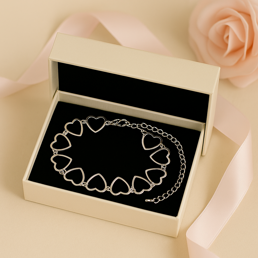 Heart-shaped bracelet in a jewelry box with a soft pink rose in the background
