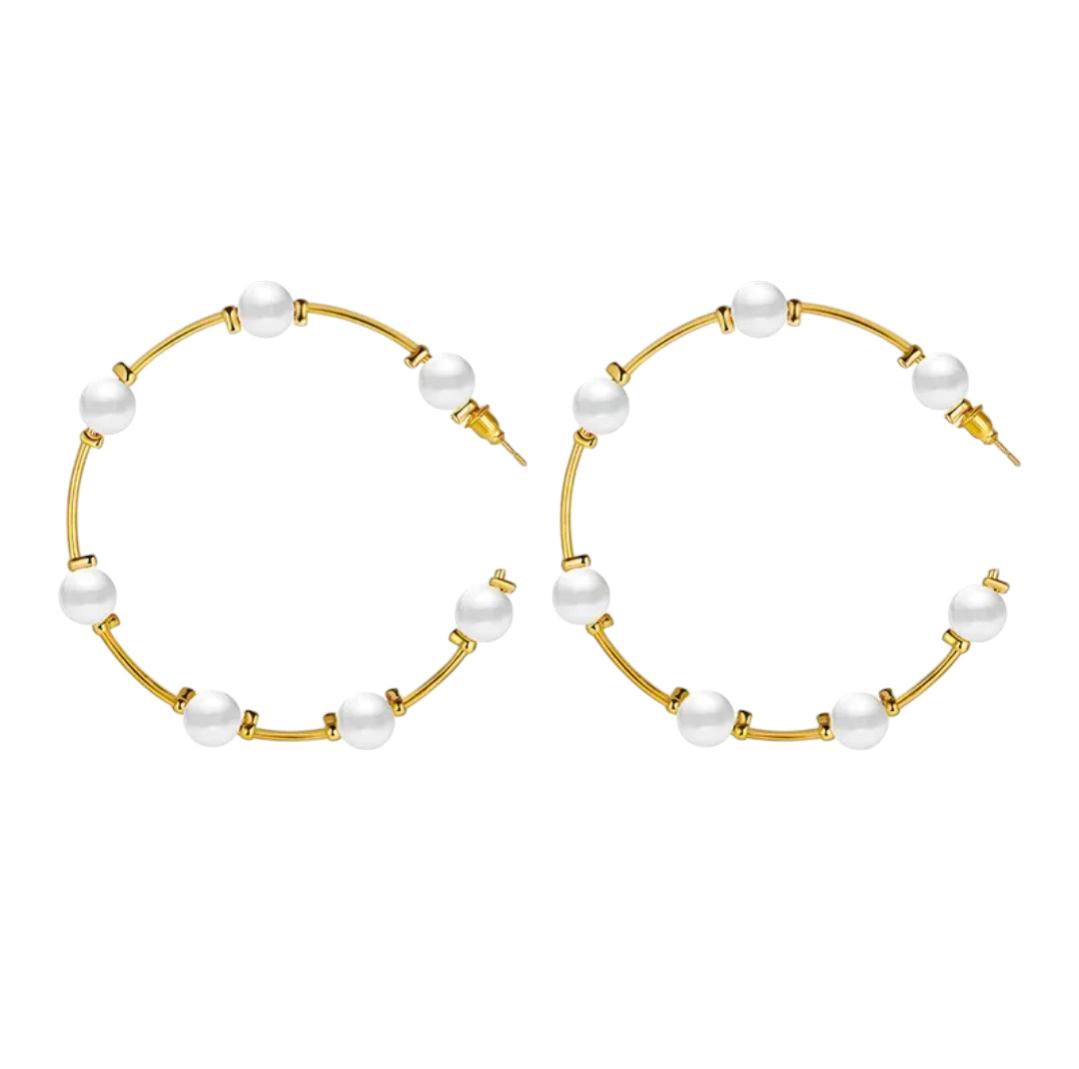 Gold hoop earrings with pearls on a white background