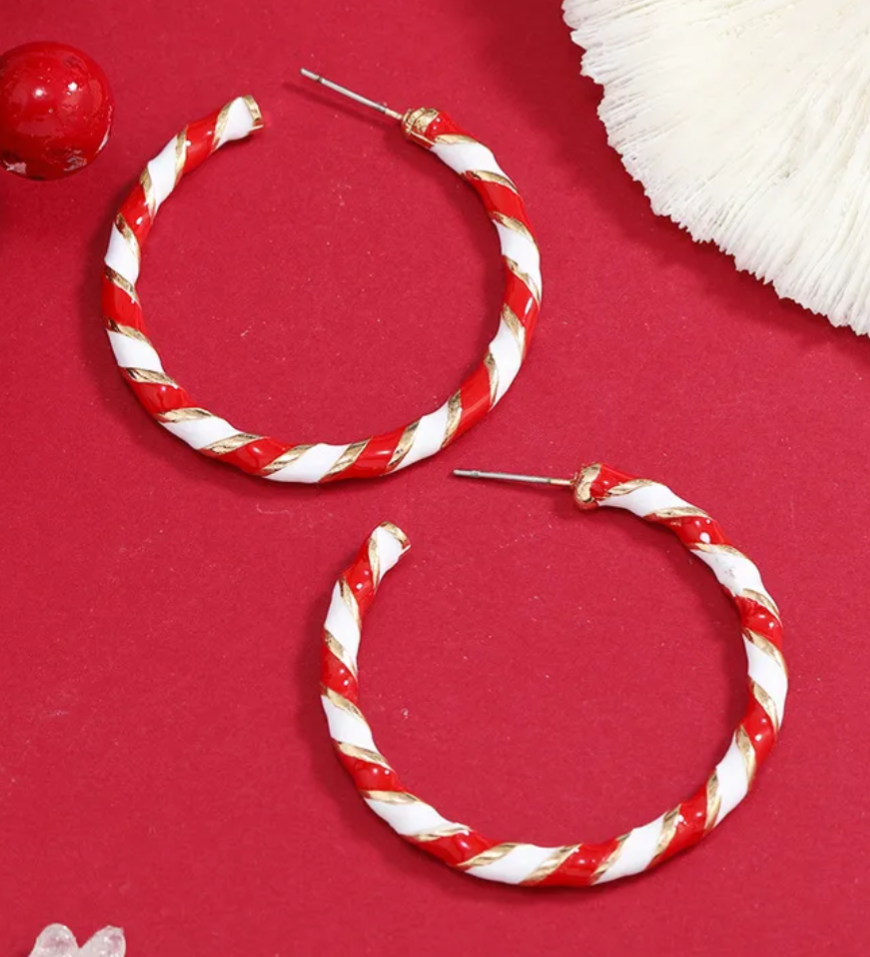 Red and white striped hoop earrings on a red background