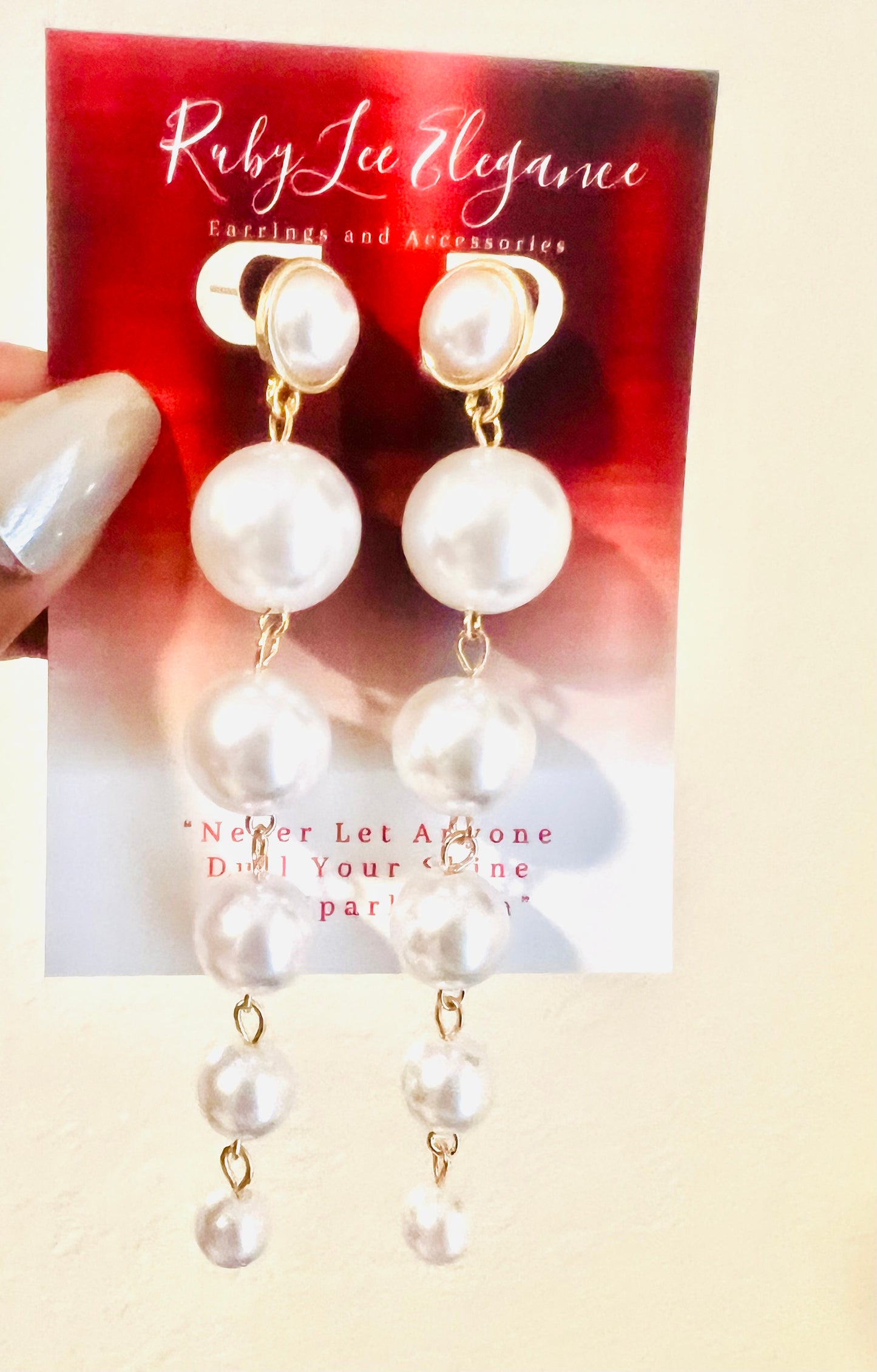 Pearl earrings on a Ruby Lee Elegance card with a red background