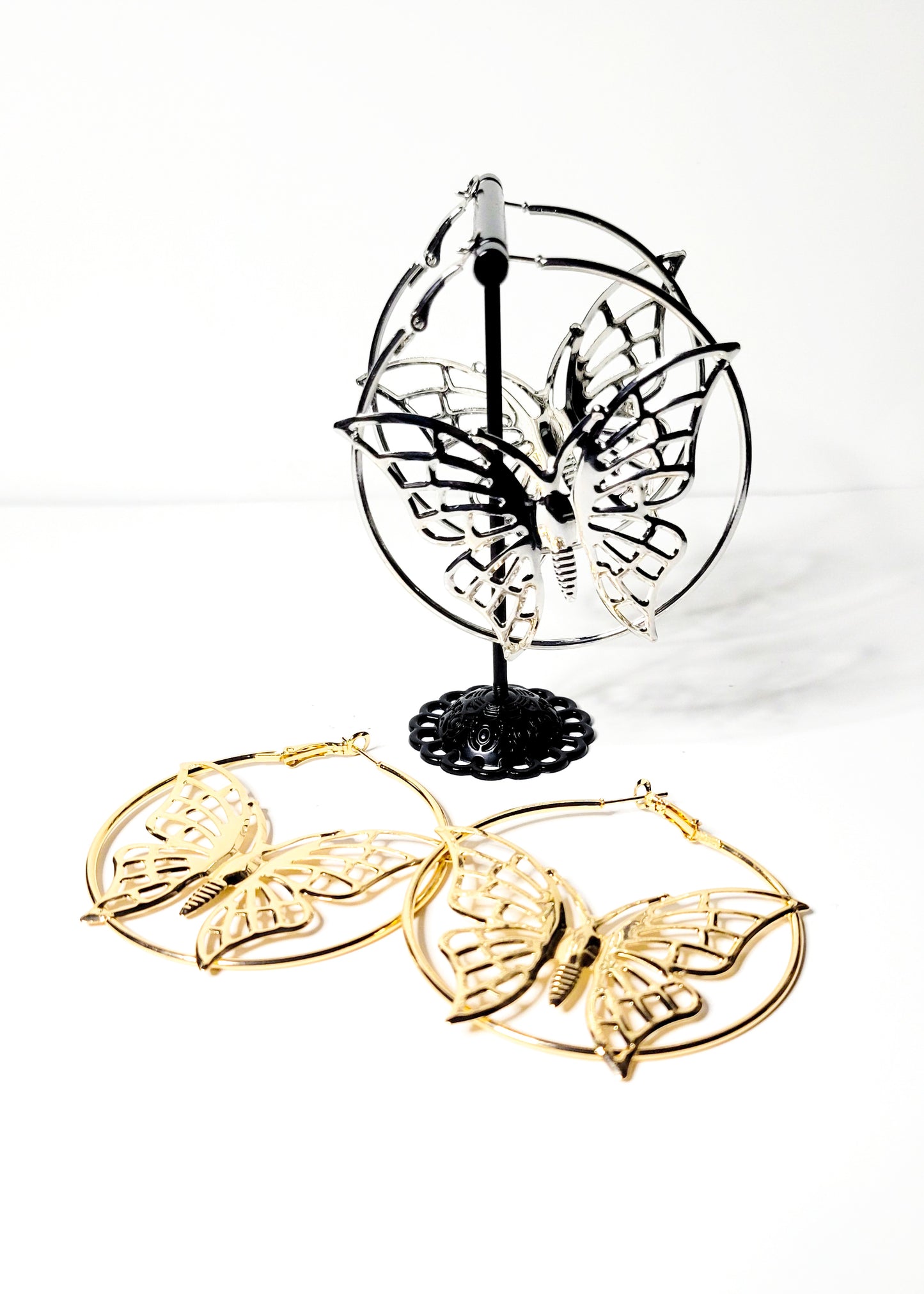 Butterfly-shaped hoop earrings available in silver and gold