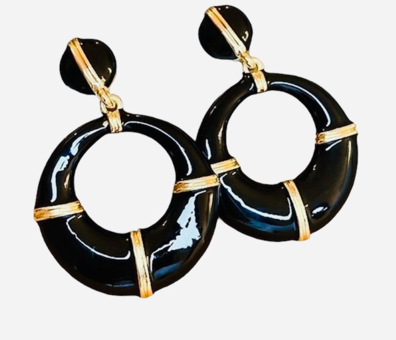 Black hoop earrings with gold accents on a white background