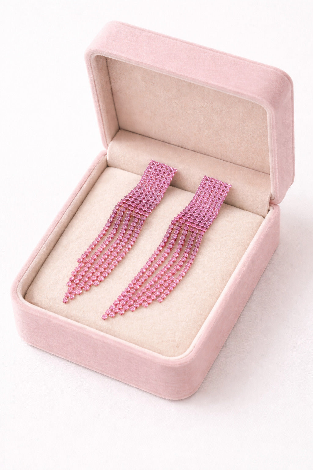 Pink beaded hairpins in a pink jewelry box on a white background