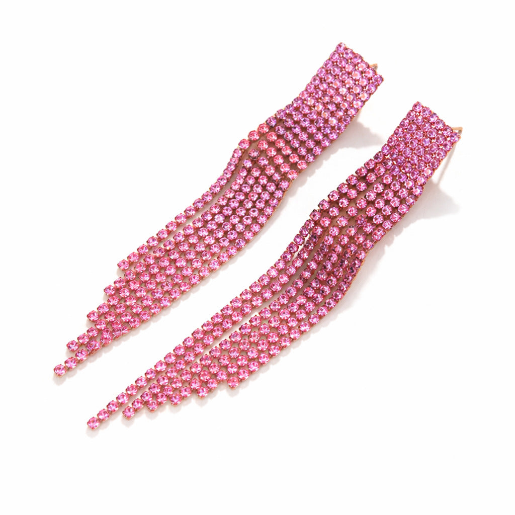Two pink rhinestone hair extensions on a white background