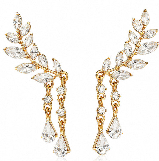 A pair of gold leaf-shaped drop earrings adorned with marquise and round clear crystals, shown against a plain white background.