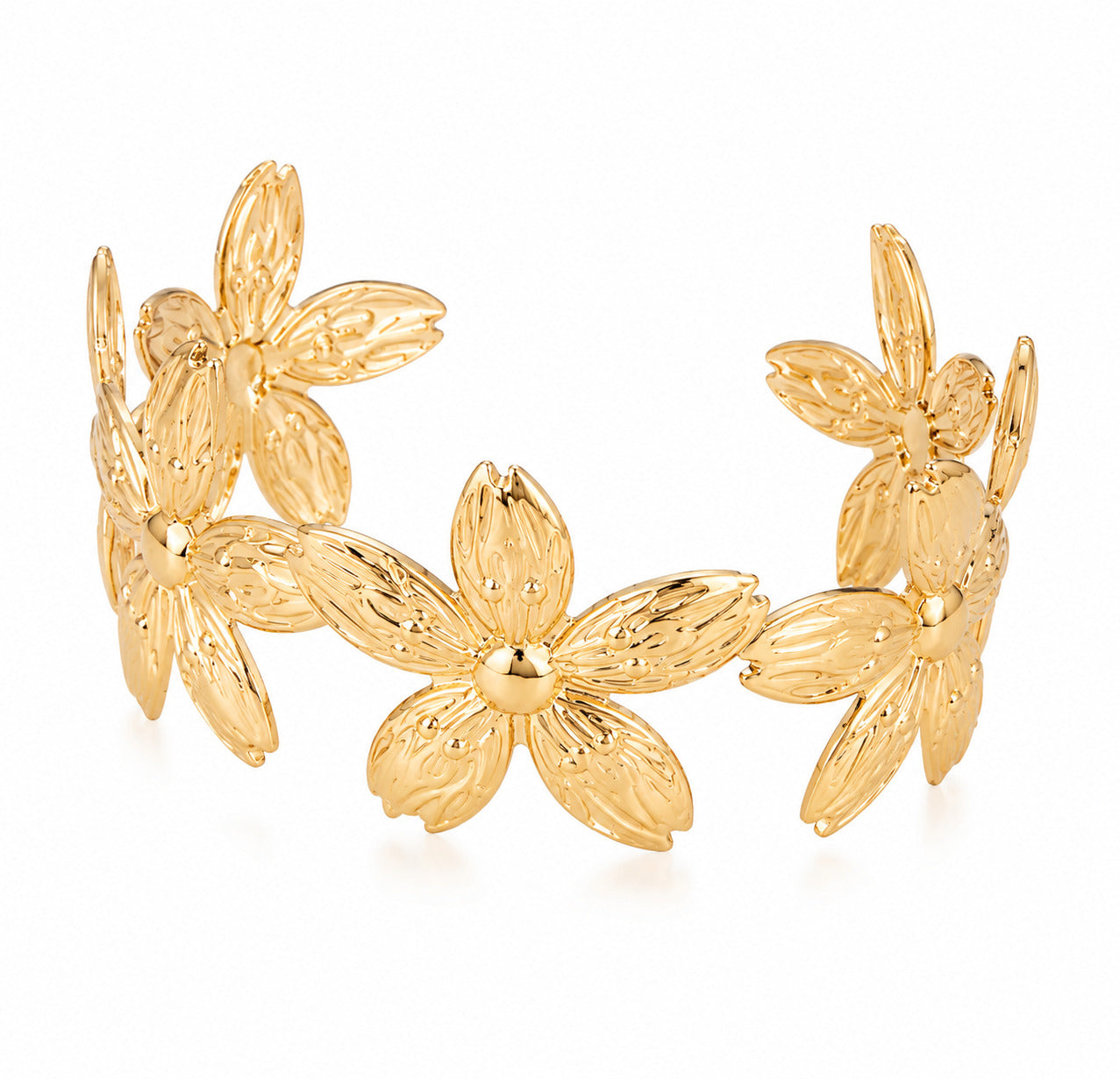 A gold-tone metal cuff bracelet featuring a continuous textured floral pattern of five-petal flowers, shown on a clean white background.