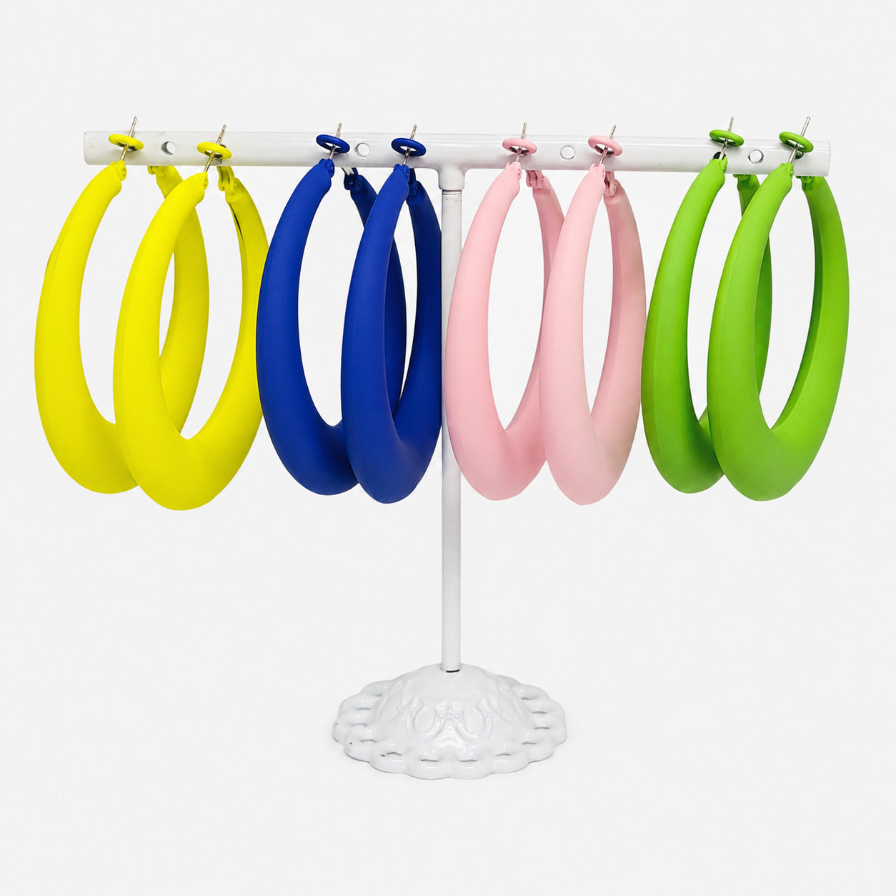 Bold Horizon Oversized Hoop Earrings available in Green, Blue, Yellow, and Light Pink. Displayed on a white jewelry stand against a clean white background.