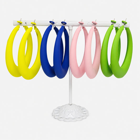Bold Horizon Oversized Hoop Earrings available in Green, Blue, Yellow, and Light Pink. Displayed on a white jewelry stand against a clean white background.