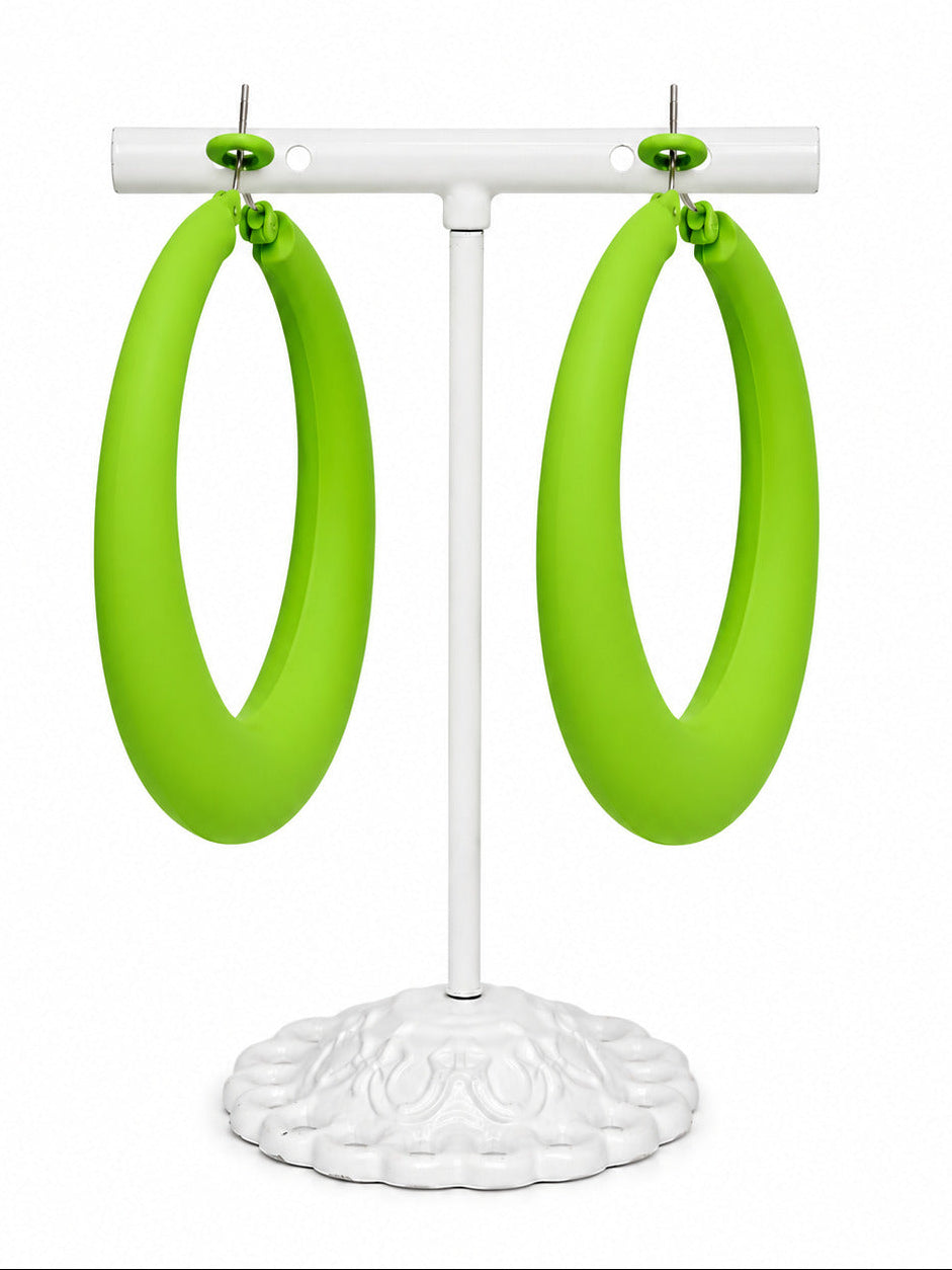 Bright lime green hoop earrings displayed on a white jewelry stand against a plain white background.