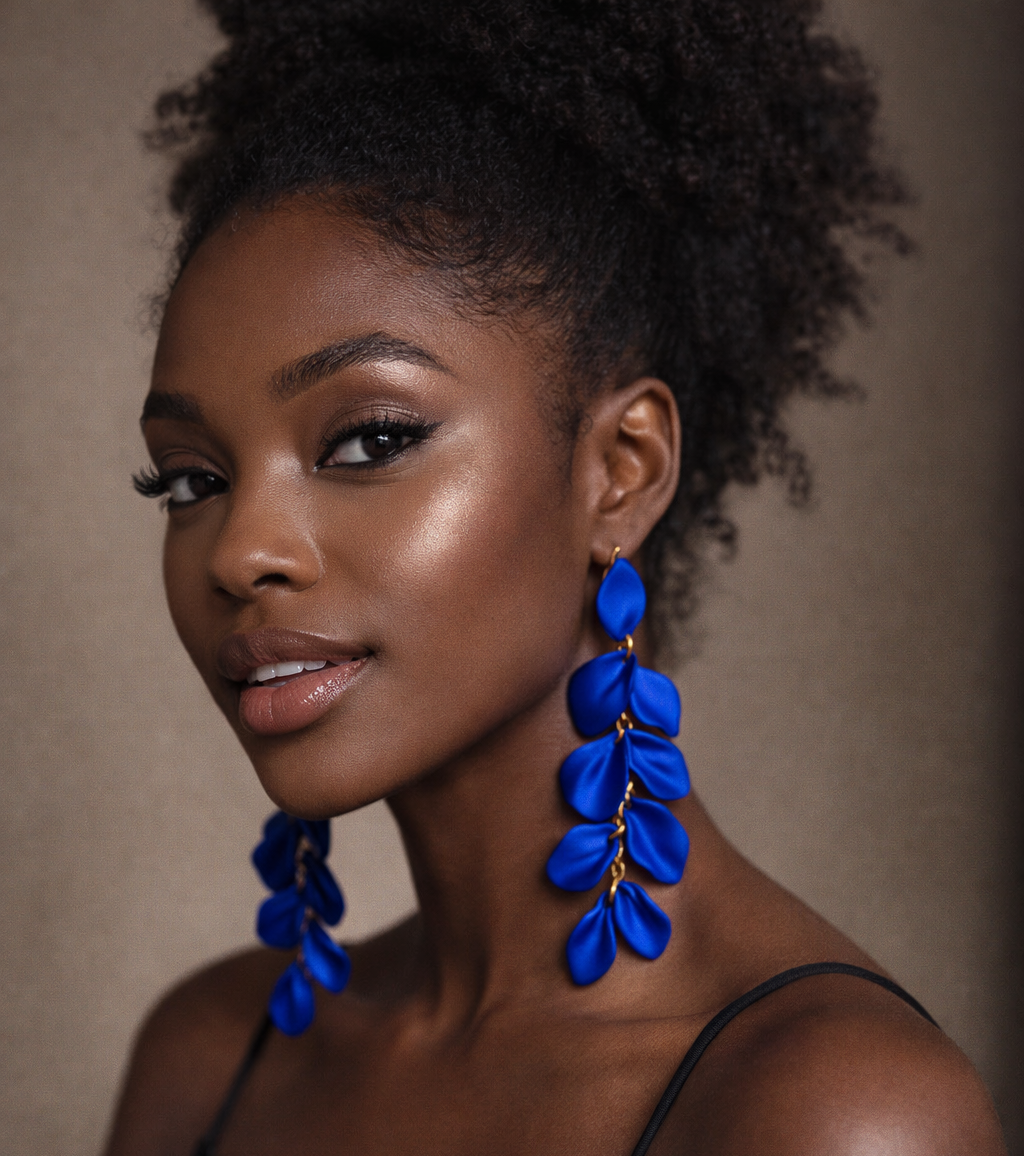 Woman wearing blue earrings against a neutral background