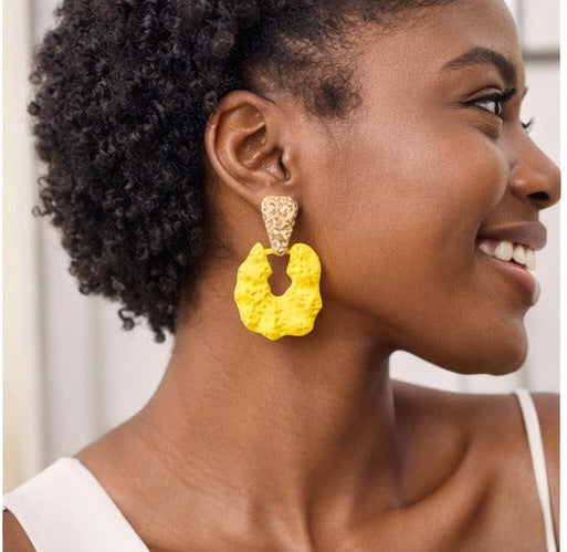 Yellow earrings displayed on models and in various settings with Walmart branding.