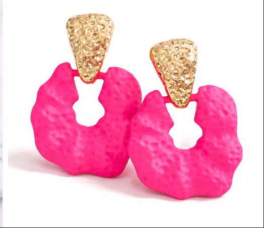 Collage of pink earrings with gold accents worn by models and displayed on a white surface.