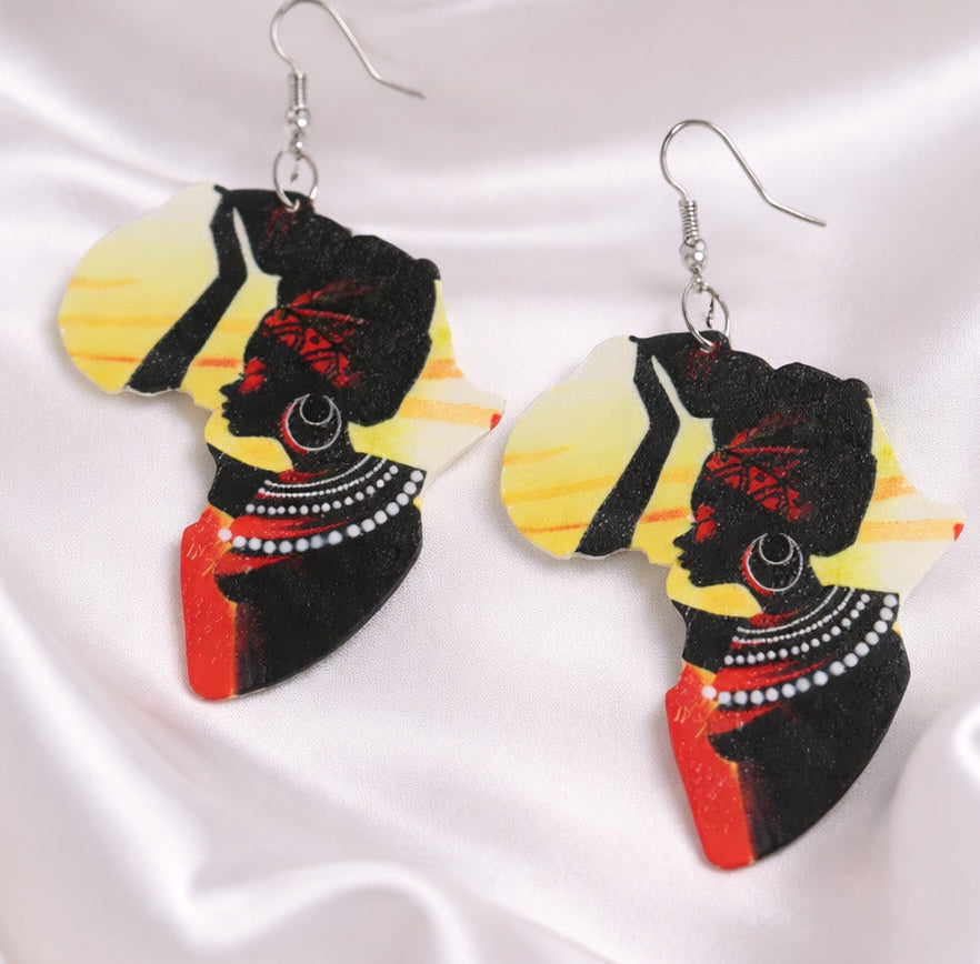 African-themed earrings on a satin background