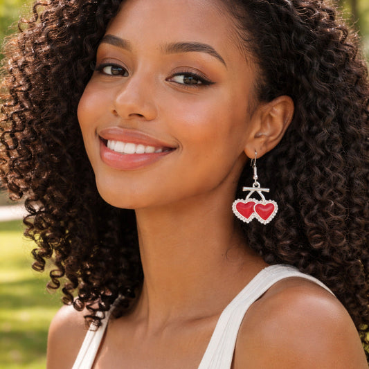 Woman wearing heart-shaped earrings outdoors