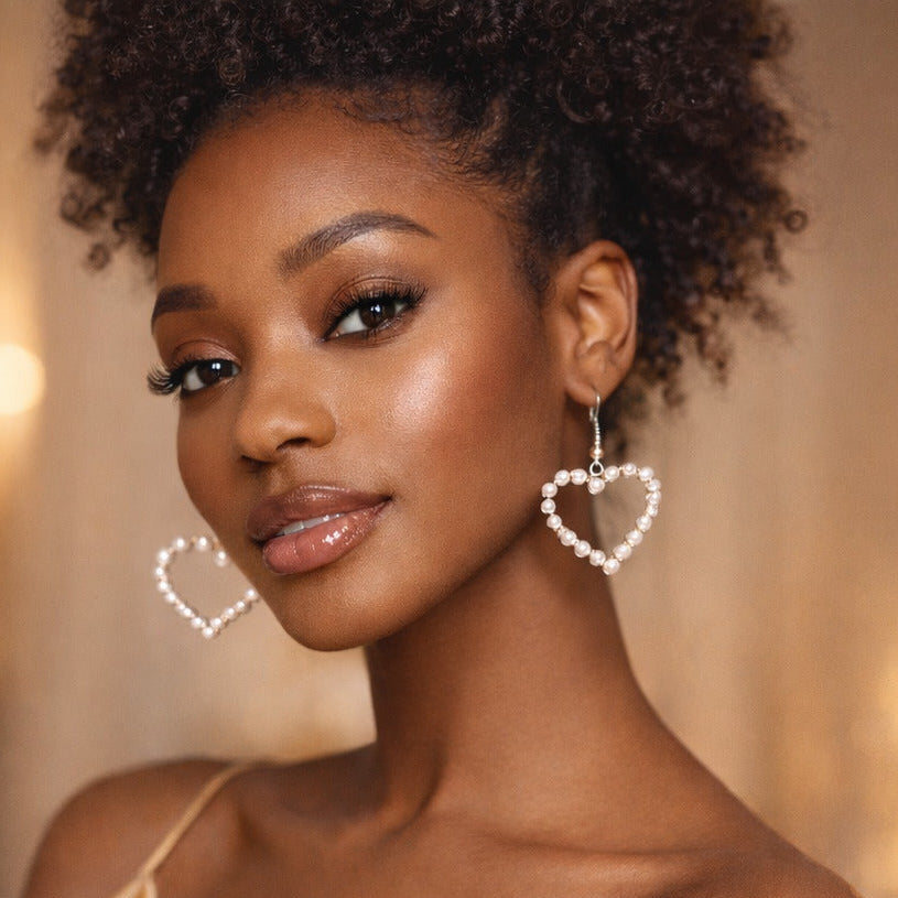 Woman wearing heart-shaped earrings with a blurred background