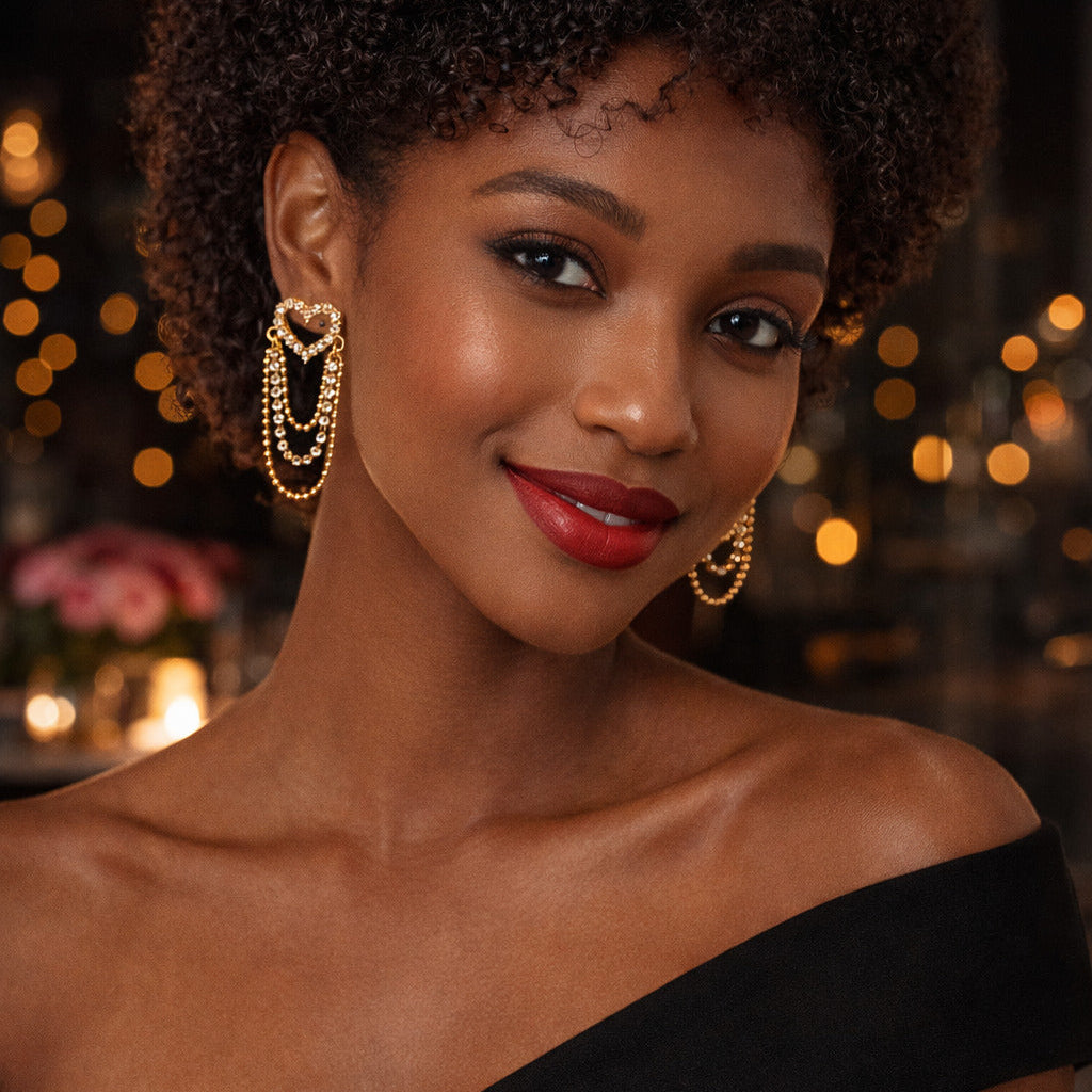 Woman wearing gold hoop earrings with a blurred background of lights