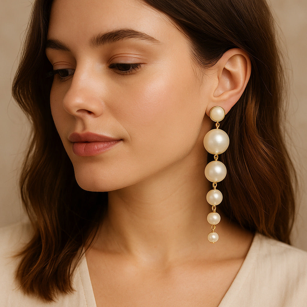 Close-up of a woman wearing pearl earrings with a neutral background