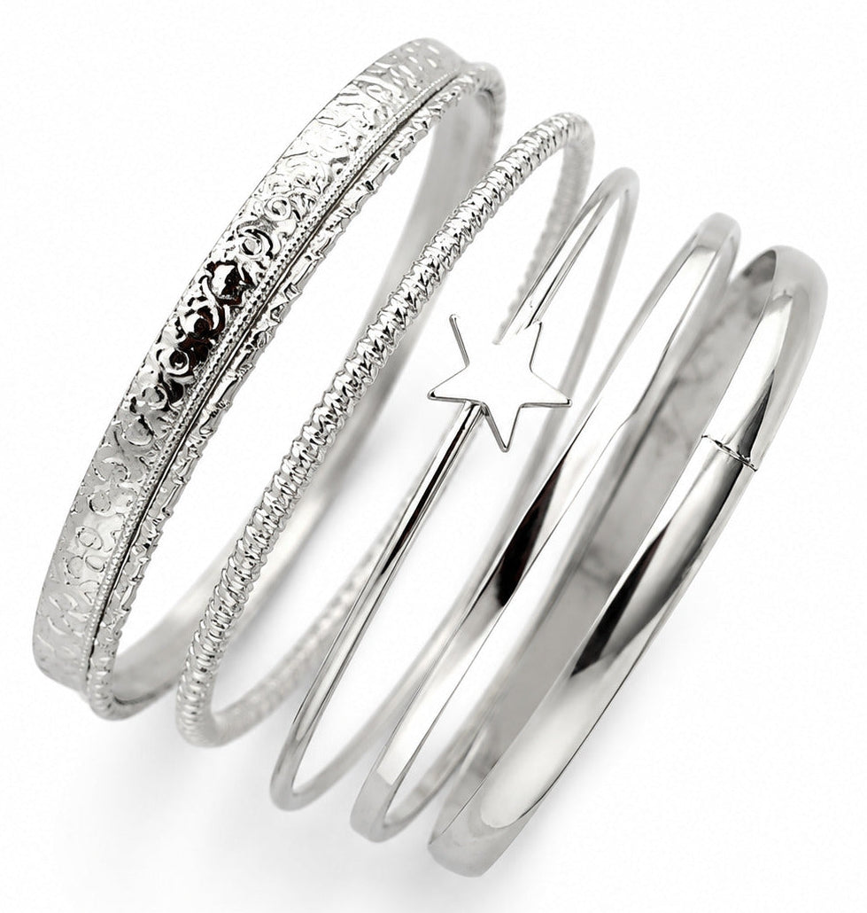 A set of five silver bangles stacked together on a white background, featuring various textures including floral engraving, beaded detailing, and a star-shaped accent.