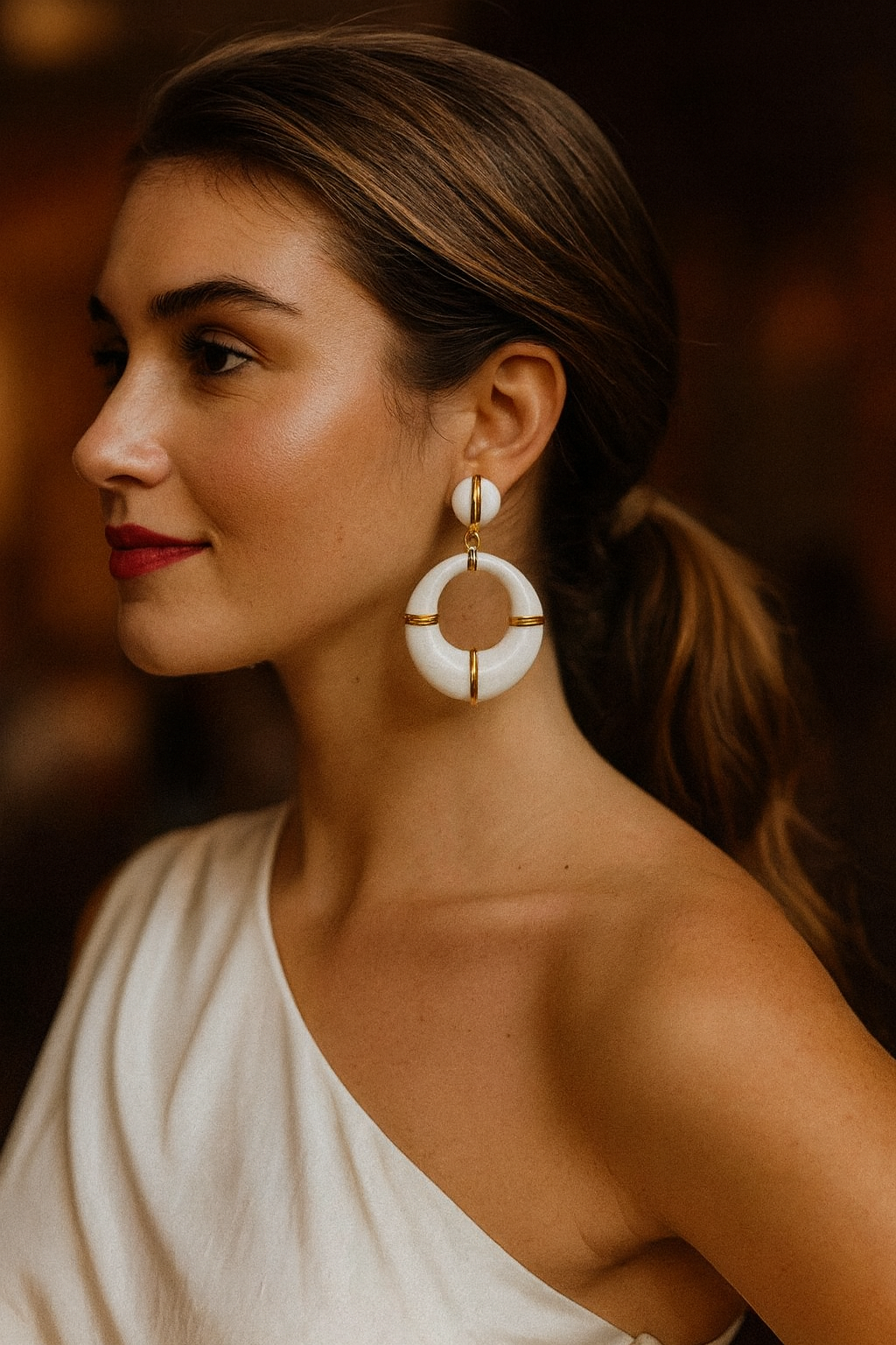 Woman wearing large hoop earrings with a blurred background