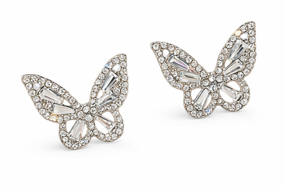 Butterfly-shaped earrings with gemstones on a white background