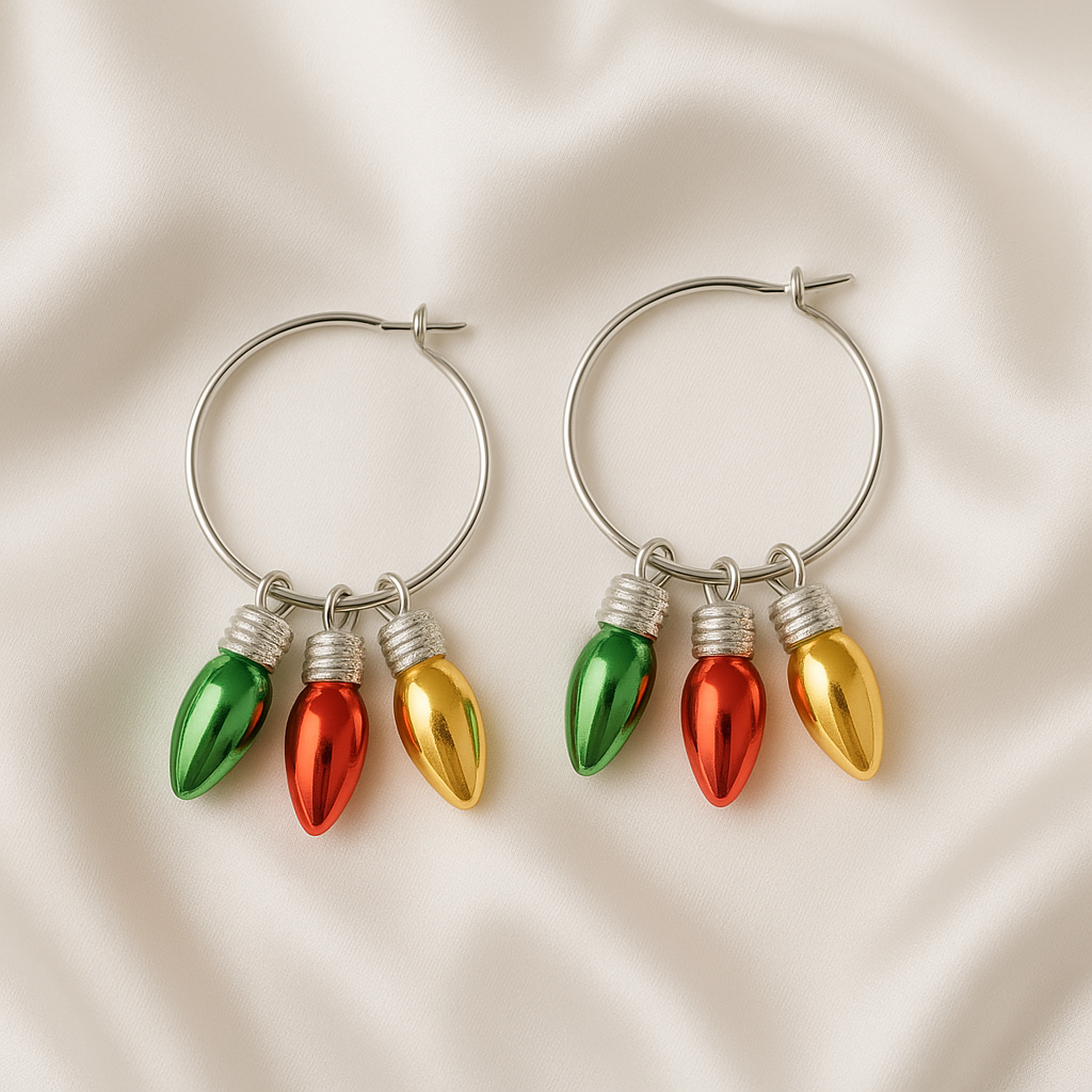 Pair of hoop earrings with colorful Christmas light bulb charms on a beige fabric background