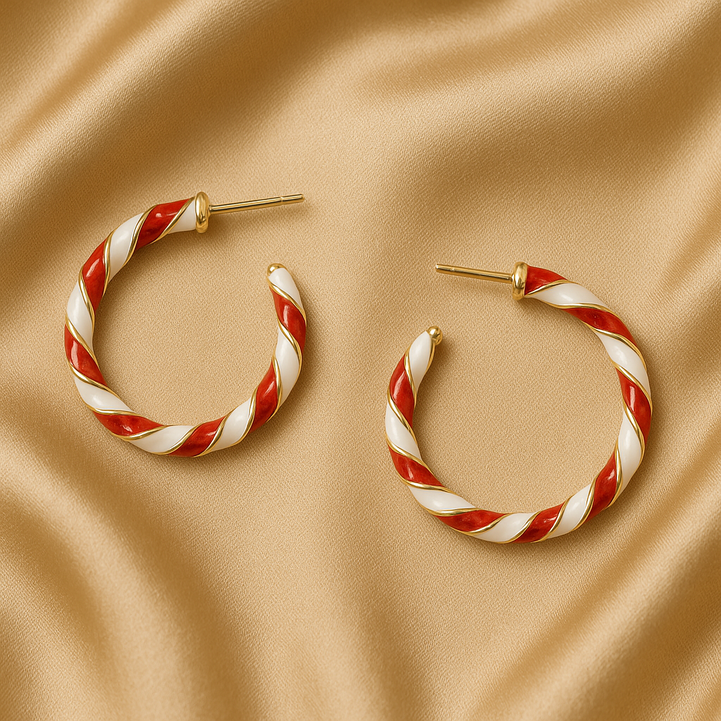 Twisted hoop earrings with red and white stripes on a beige fabric background