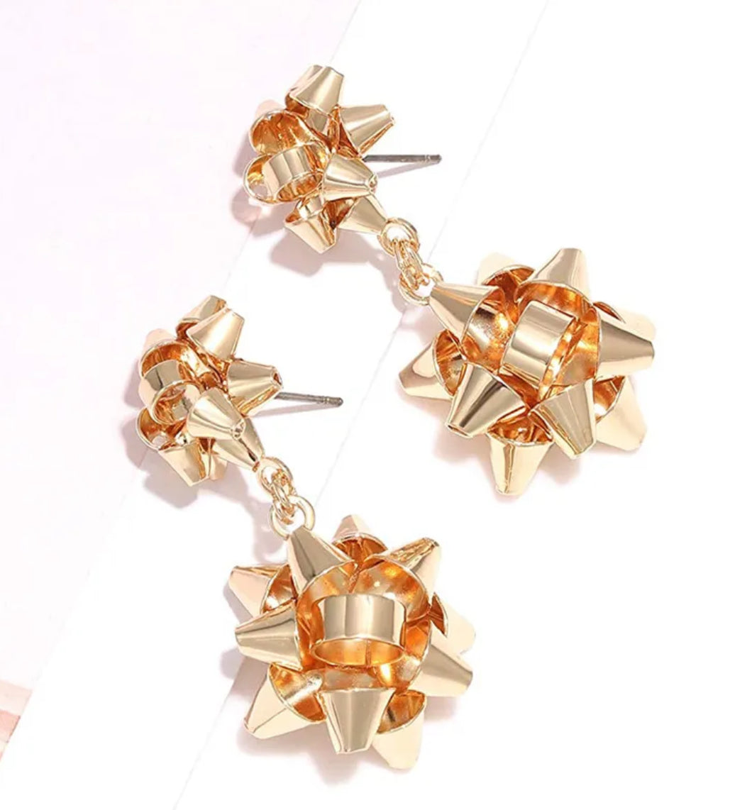 Gold geometric earrings on a white background