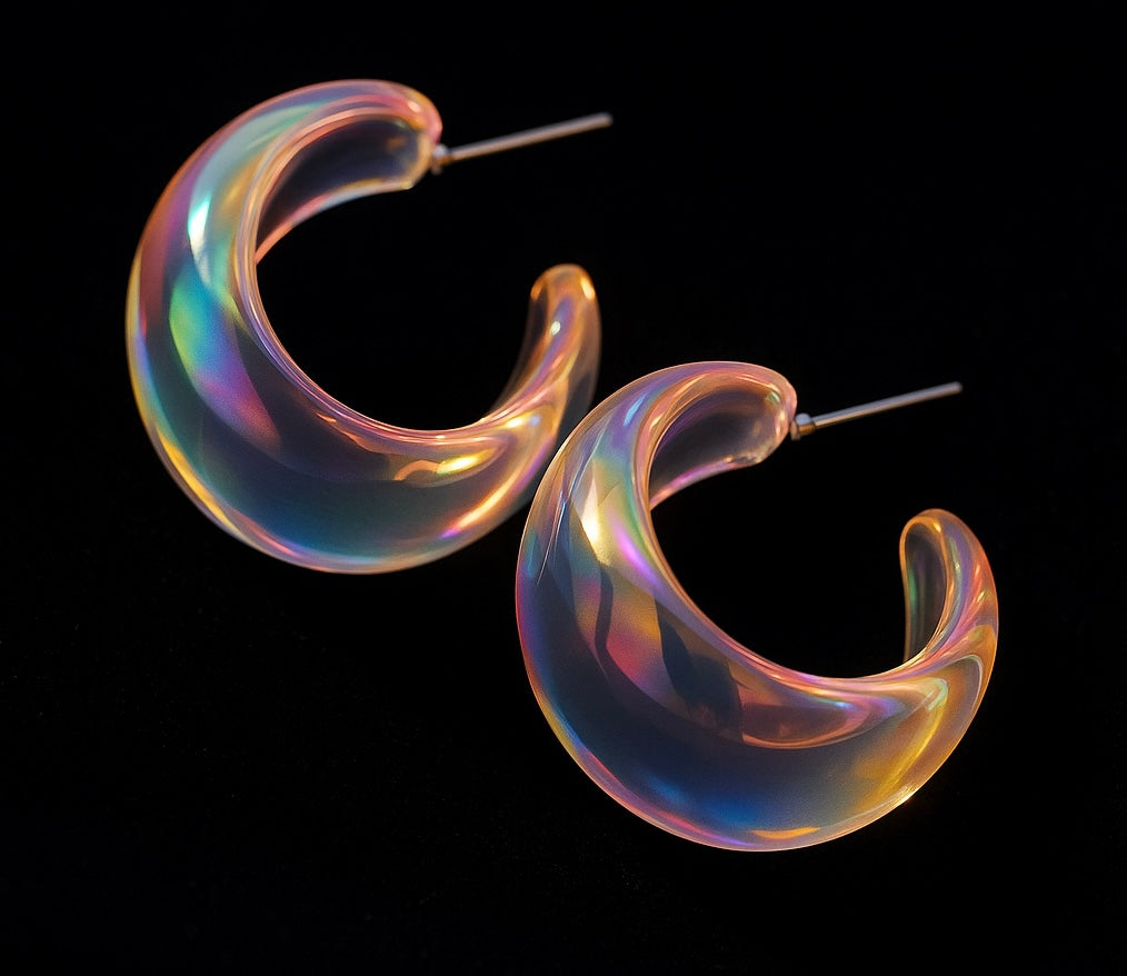 Iridescent hoop earrings on a black background