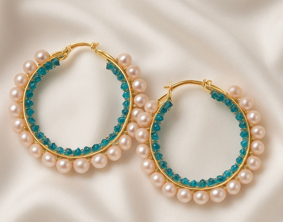 Hoop earrings with pearl and blue gemstone accents on a white background
