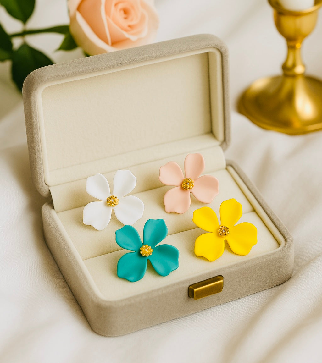 Colorful flower-shaped earrings in a jewelry box with a soft focus background
