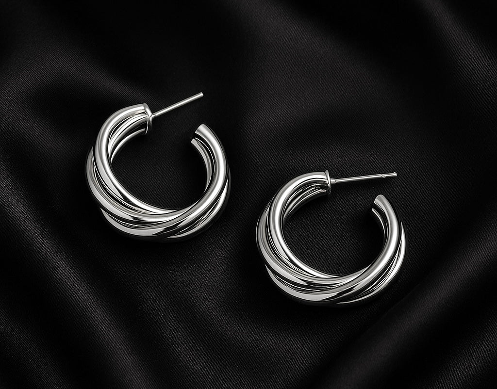 silver hoop earrings, interlocked hoop earrings, twisted hoops, minimalist silver jewelry, trendy earrings, elegant hoop earrings, fashion jewelry for women, statement hoops, everyday jewelry style, silver earrings aesthetic, classy earrings, chic accessories, timeless jewelry, modern earrings, jewelry gift ideas