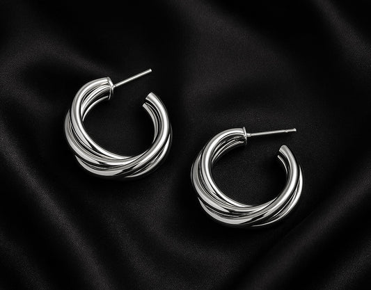 silver hoop earrings, interlocked hoop earrings, twisted hoops, minimalist silver jewelry, trendy earrings, elegant hoop earrings, fashion jewelry for women, statement hoops, everyday jewelry style, silver earrings aesthetic, classy earrings, chic accessories, timeless jewelry, modern earrings, jewelry gift ideas