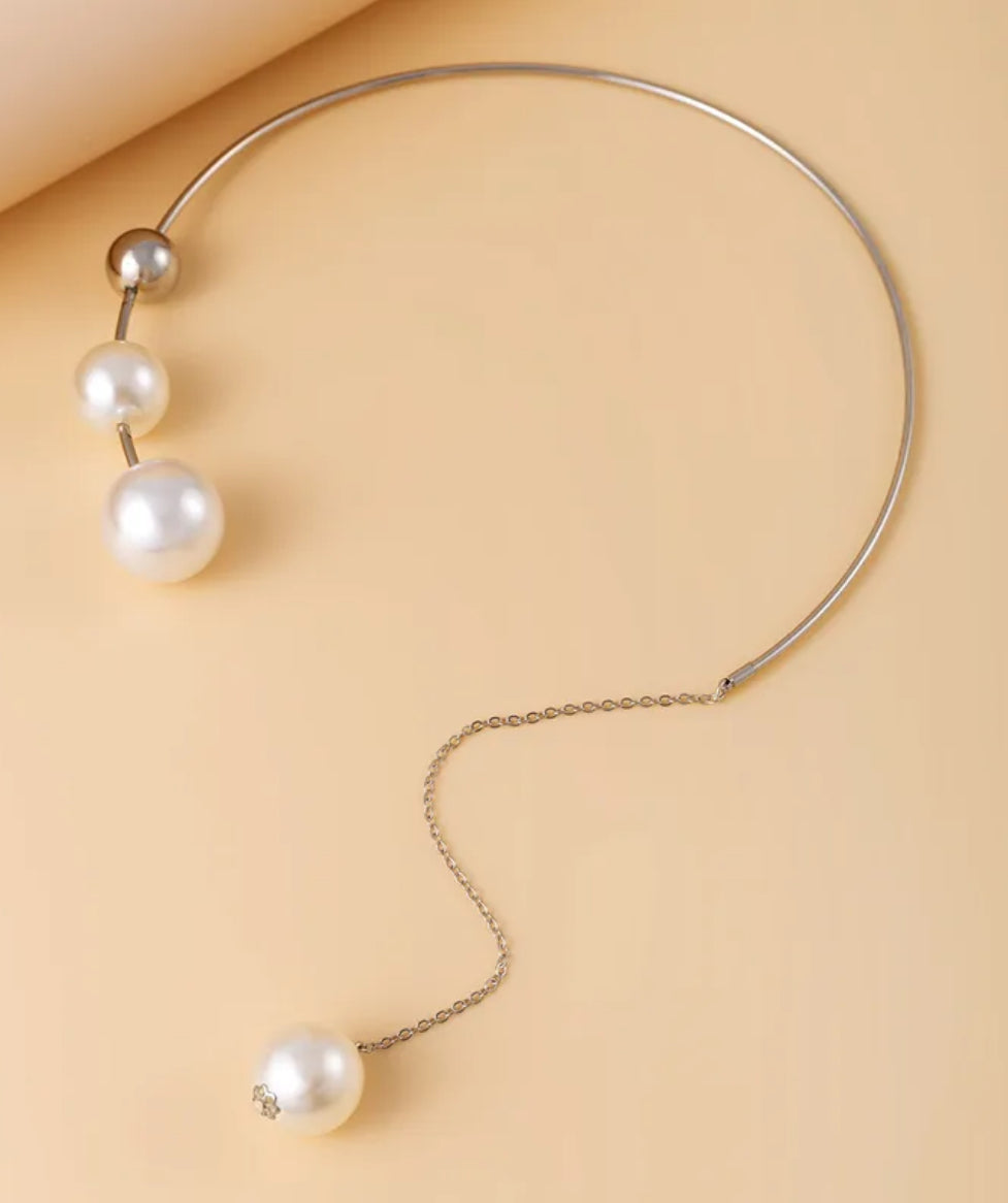 Necklace with pearls on a beige background