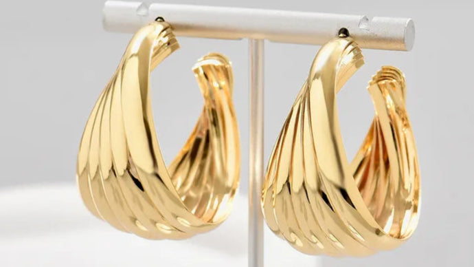 Gold hoop earrings on a white background