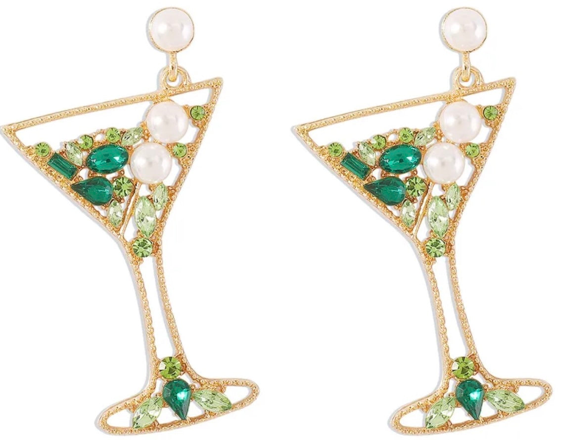 Gold martini glass earrings with green gemstones and pearls on a white background