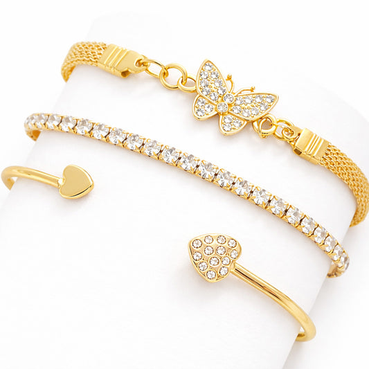 Set of gold bracelets with butterfly and heart designs on a white background
