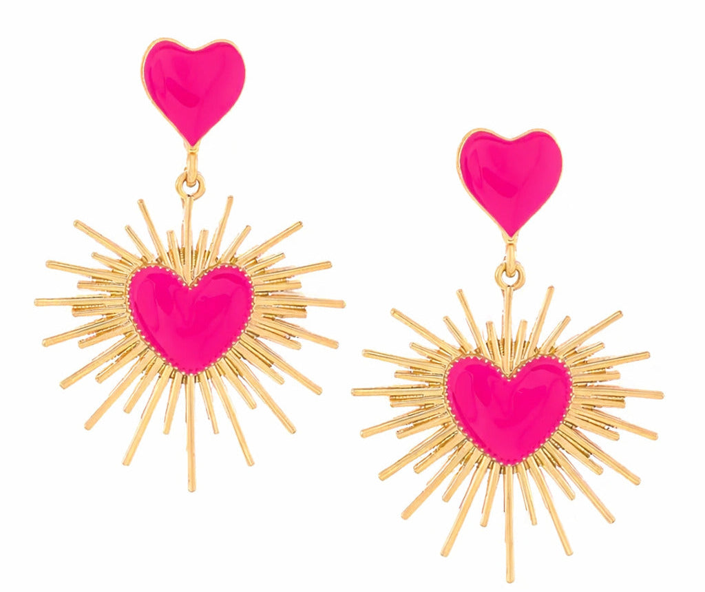 Pair of earrings with pink heart-shaped tops and gold sunburst designs on a white background