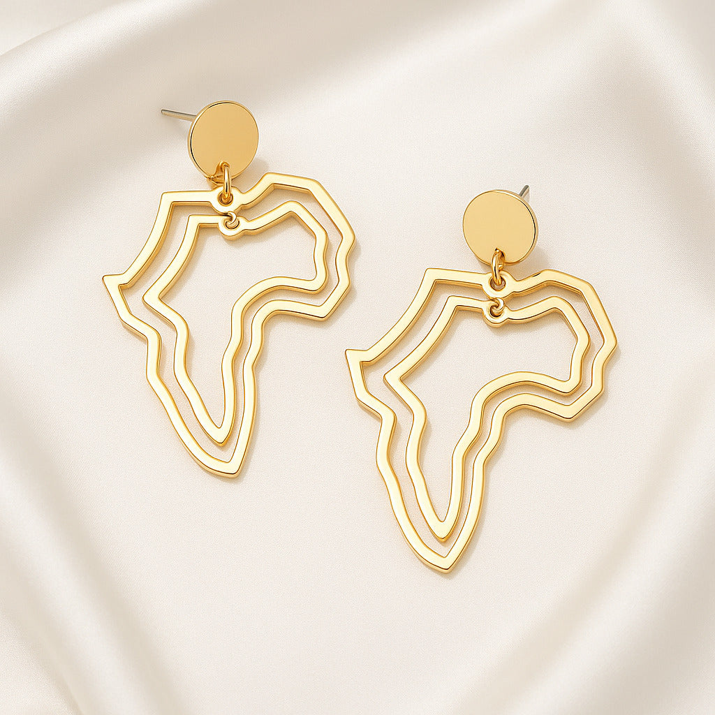 Gold abstract earrings on a light background