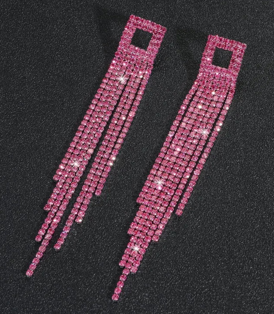 Pink rhinestone hair clips on a black background
