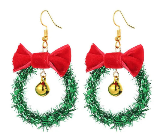 Christmas-themed earrings with green wreath and red bow design on a white background