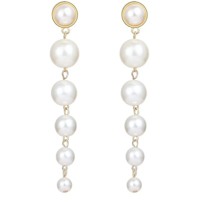 A pair of pearl drop earrings with gold accents and layered pearl beads.
