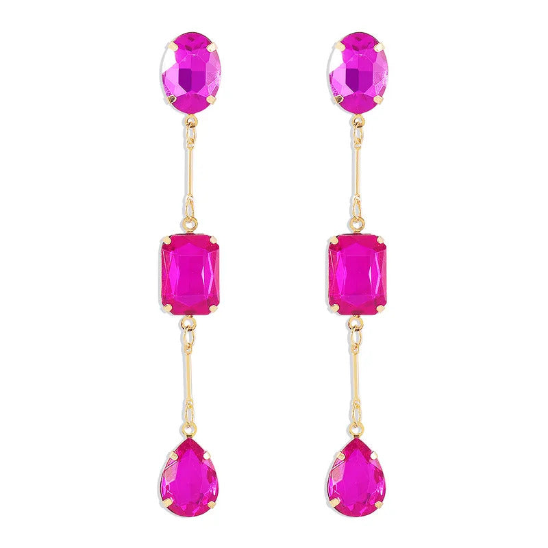 Pair of pink gemstone earrings with gold accents on a white background