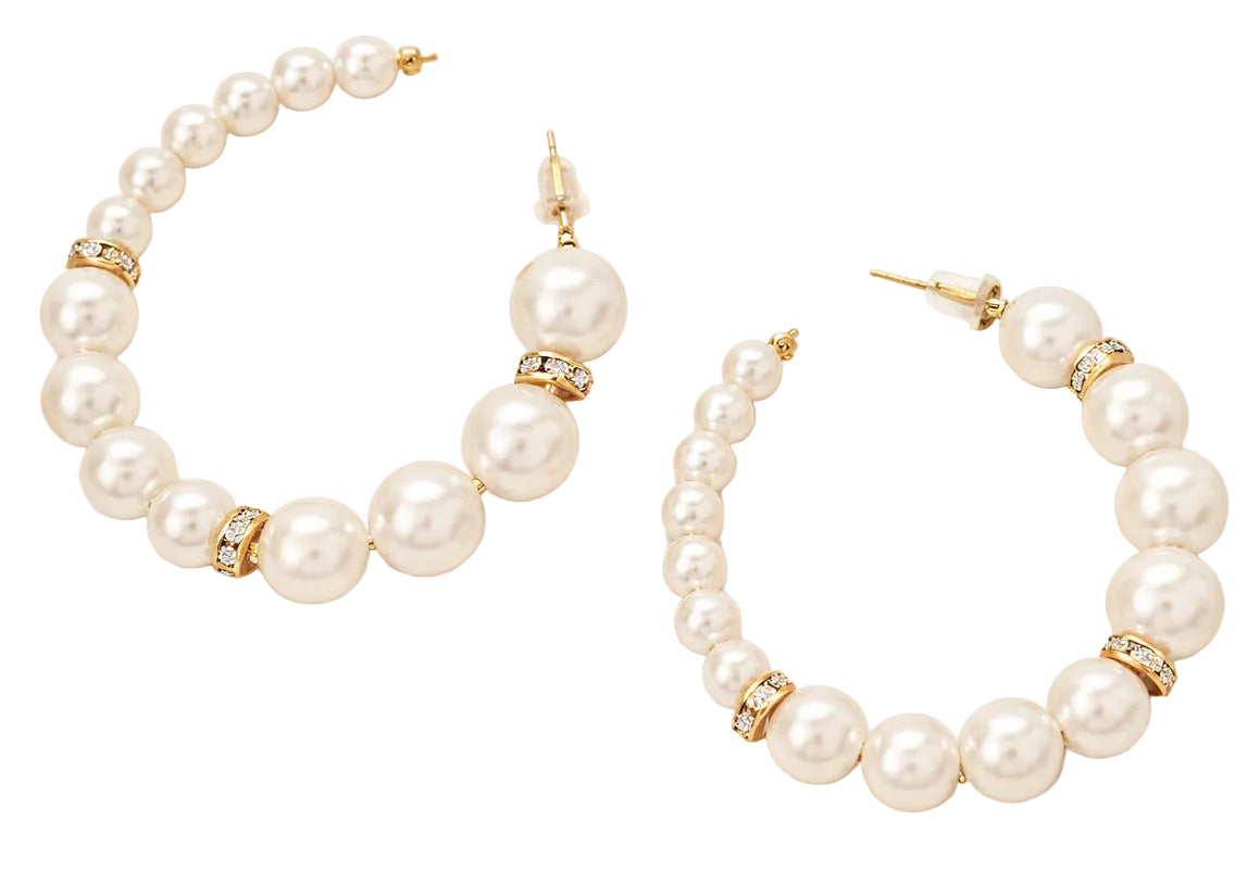 Pearl hoop earrings with gold accents on a white background