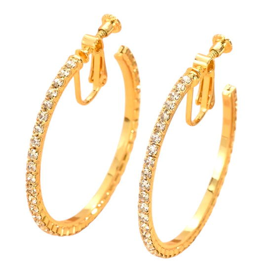 Gold hoop earrings with clear gemstones on a white background