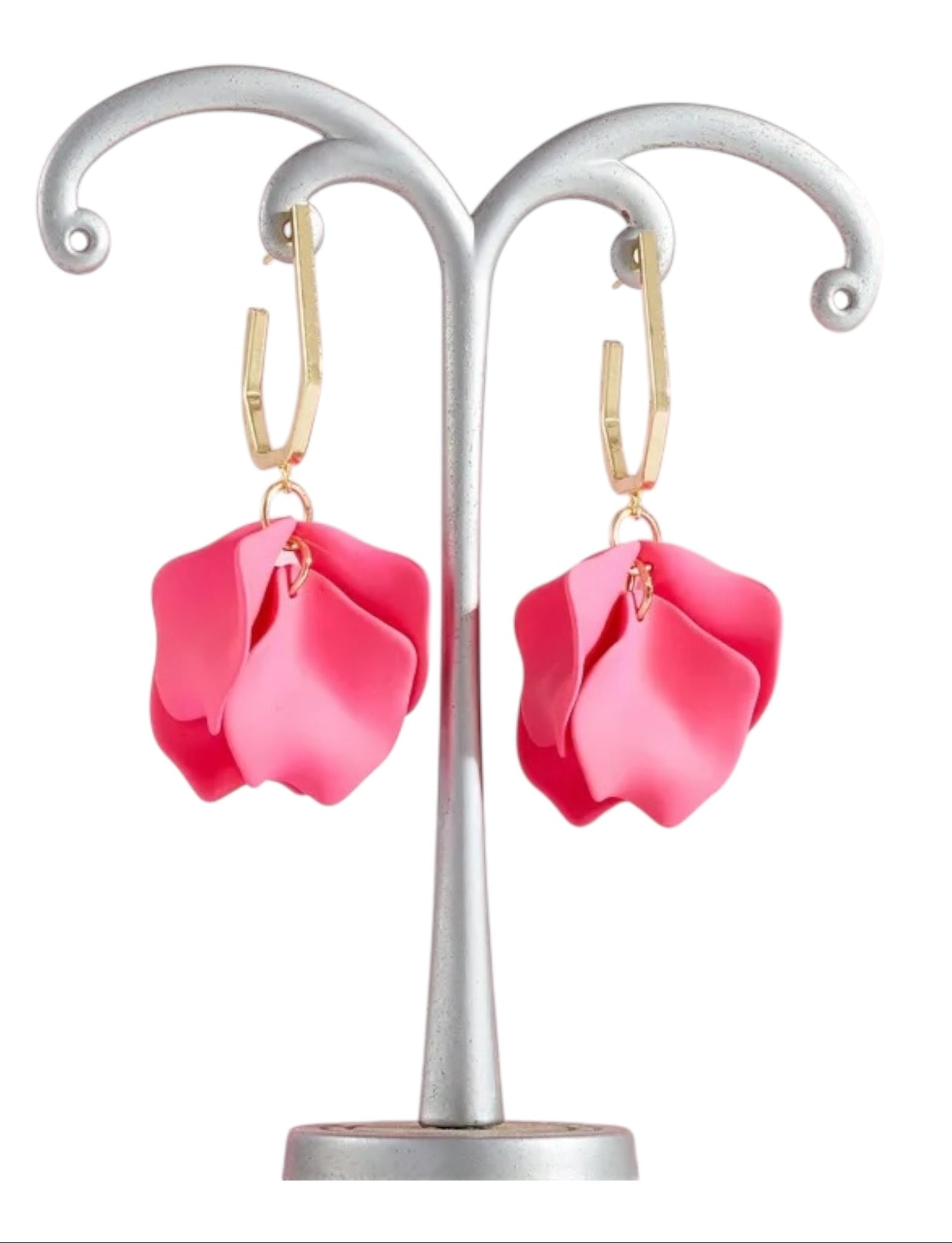 Pink flower-shaped earrings on a silver stand with a white background